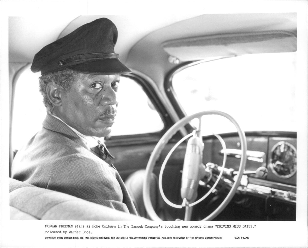 Morgan Freeman sitting in a driving seat looking back in a scene of 19