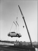 The new Mazda 323 is lifted into Berzeliiterassen. - Vintage Photograph