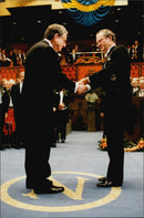 Nobel Prize winner in medicine, Dr. Alfred G. Gilman, receives his award from King Carl XVI Gustaf in Stockholm Concert Hall - Vintage Photograph