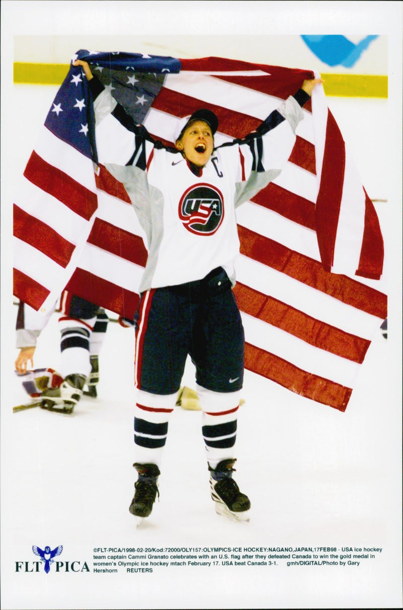 United States ice hockey team captain Cammi Granato with an American flag after winning Canada during the Winter Olympics in Nagano 1998 - Vintage Photograph