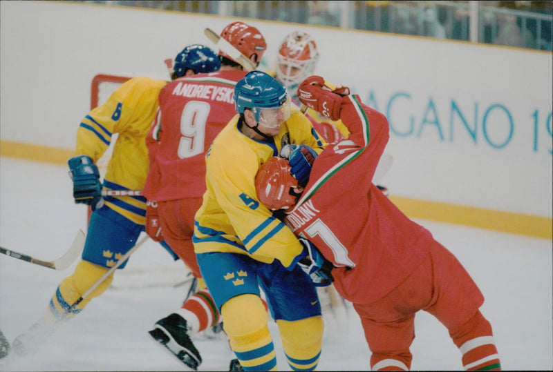 Ice hockey player in close combat during the ice hockey match Sweden - Belarus during the Winter Olympics in Nagano 1998 - Vintage Photograph