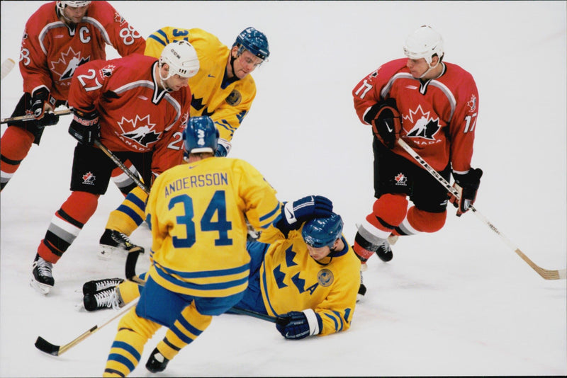 Ice hockey player fighting for the puck during the ice hockey match Sweden - Canada during the Winter Olympics in Nagano 1998 - Vintage Photograph