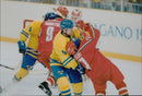 Ice hockey player in close combat during the ice hockey match Sweden - Belarus during the Winter Olympics in Nagano 1998 - Vintage Photograph
