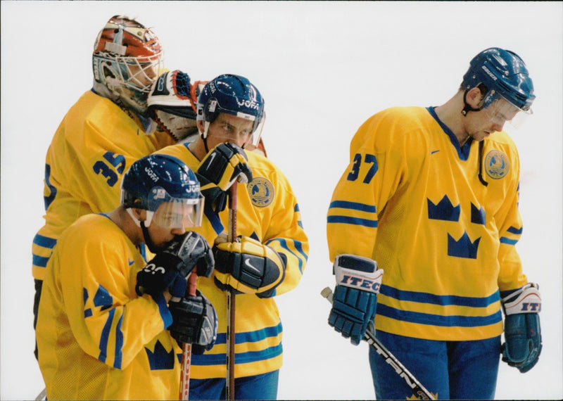 Ice hockey players Tommy Salo, Andreas Johansson, Patric Kjellberg and Nicklas SundstrÃ¶m are scattering the loss against Finland during the Winter Olympics in Nagano 1998 - Vintage Photograph