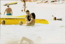 Singer Michael Hutchence is bathing together with daughter Tiger Lily. - Vintage Photograph