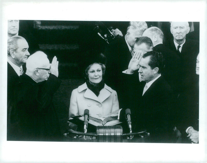 Richard Nixon swears the president. In the middle, his wife Pat and television chief Earl Warren are seen - Vintage Photograph