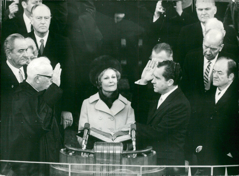 Richard Nixon swears the president. In the middle, his wife Pat and television chief Earl Warren are seen - Vintage Photograph