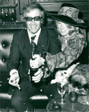 Peter Sellers and his new wife Miranda Quarry open a bottle of champagne at their wedding reception - Vintage Photograph