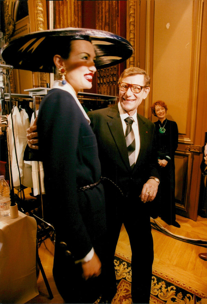 Yves Saint-Laurent together with one of the models during the premiere of the winter collection. - Vintage Photograph