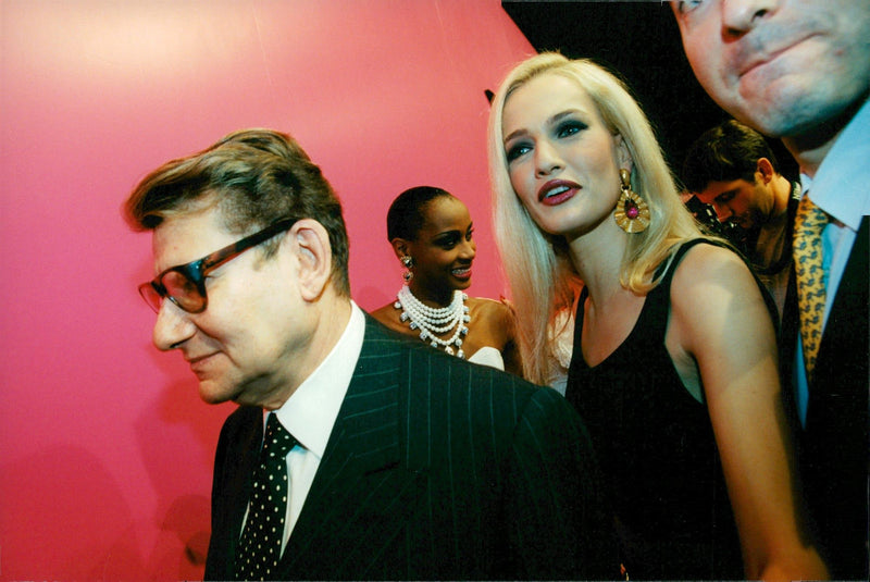 Yves Saint-Laurent followed by models and photographers. - Vintage Photograph