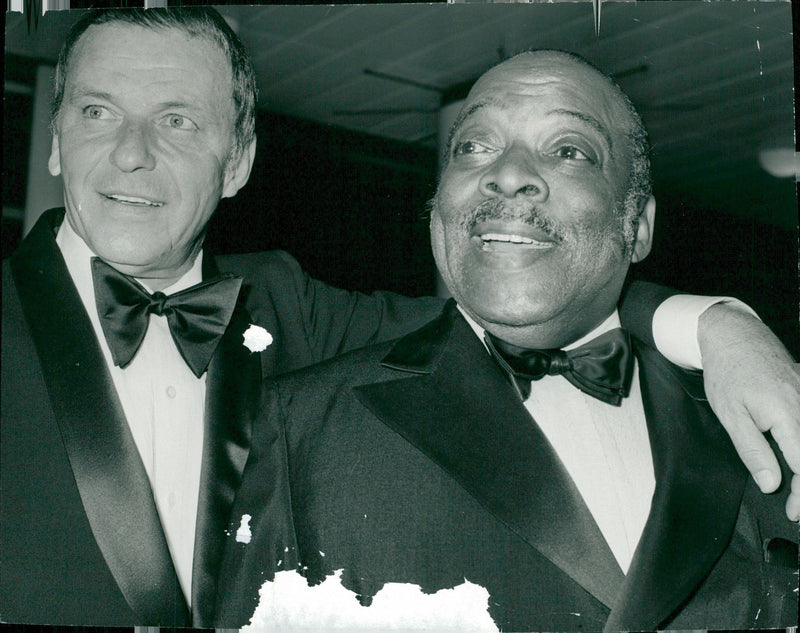 Charity concert. Frank Sinatra has his arm around the shoulders of American band leader Count Basie at the Royal Festival Hall in South Bank, London. - Vintage Photograph