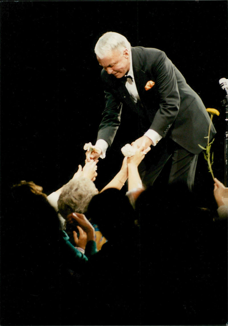 Frank Sinatra receives flowers from the audience after a concert in London. - Vintage Photograph