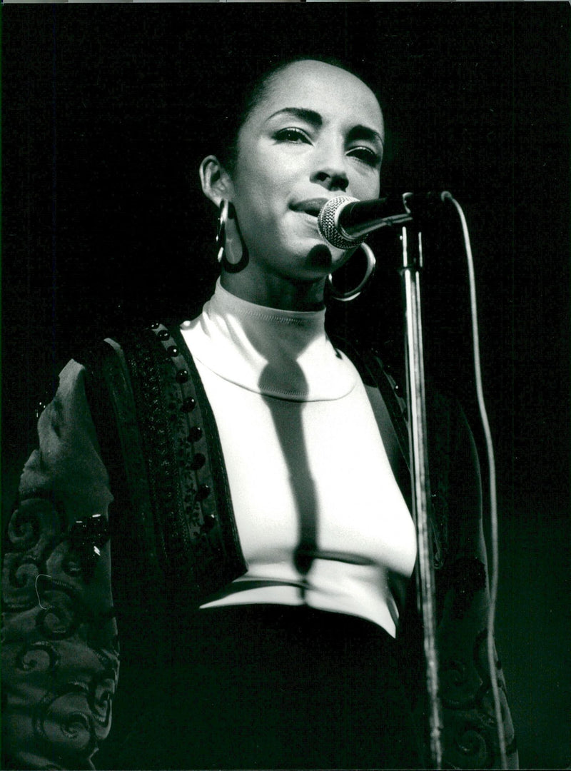 Sade, music artist, at the microphone on stage - Vintage Photograph