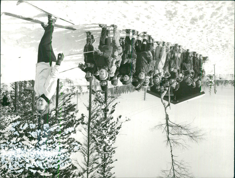 A group of children with skis are following their miss on skis in a snowy landscape - Vintage Photograph
