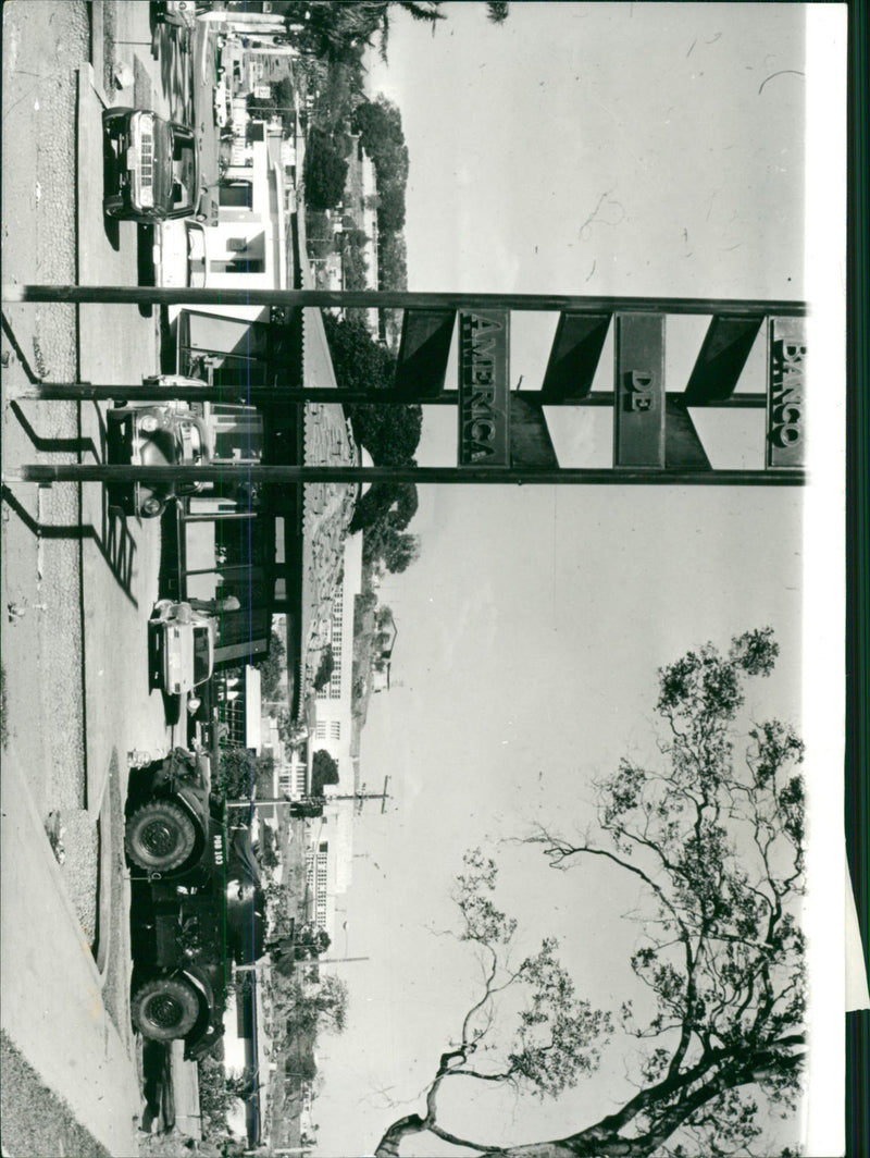 A tanks stand guard outside a bank office of the Bank of America - Vintage Photograph