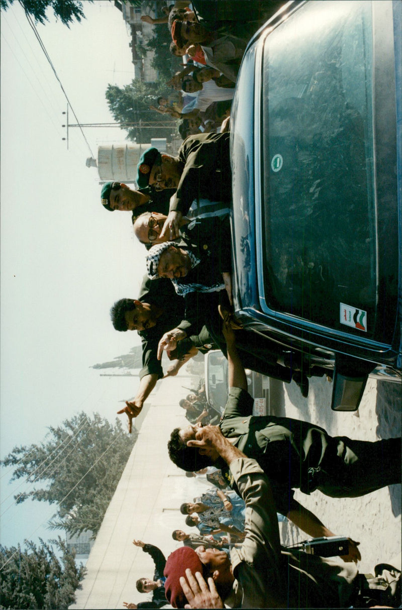 Yasser Arafat is open in his bulletproof Mercedes on the street and greets people after 27 years of exile - Vintage Photograph