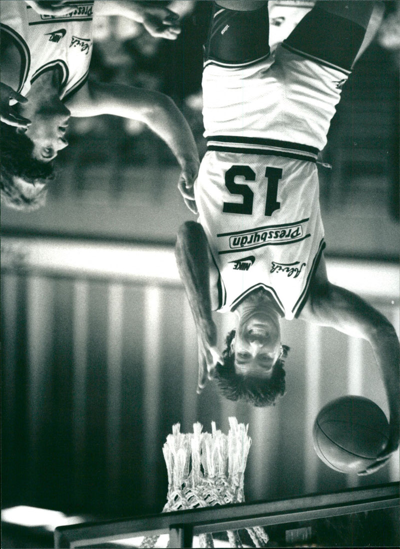 Sam Foggin dumps basketball in the net during a match - Vintage Photograph