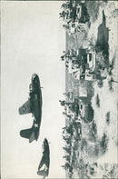 Two pictures, one showing a department of American tanks crossed by two bombers, the second picture shows a family. - 24 December 1942 - Vintage Photograph