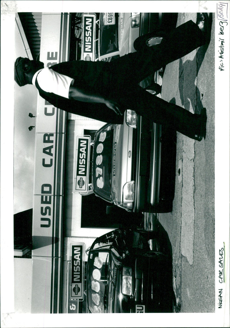 Second hand Nissan cars on display in a showroom - Vintage Photograph