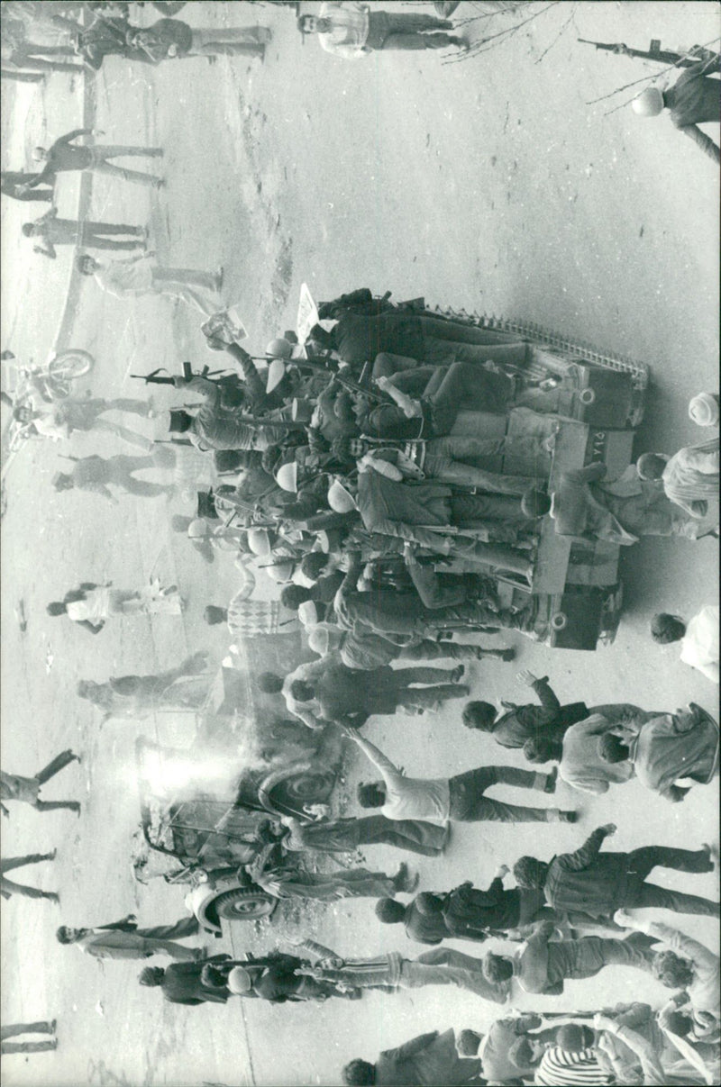 Civil rebels and soldiers take over tanks near the Doshen Tappeh Air Base - Vintage Photograph