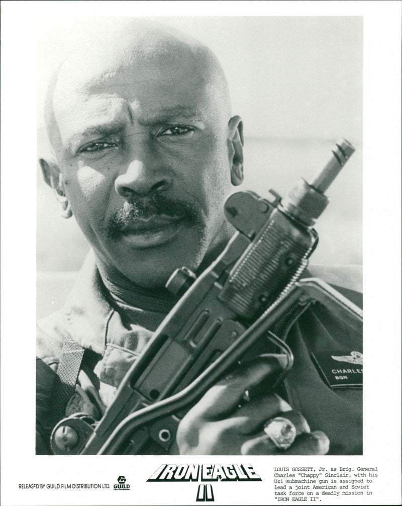 Louis Gossett Jr. as Brig. General Charles with his submachine gun in 1988's film "Iron Eagle II" - Vintage Photograph