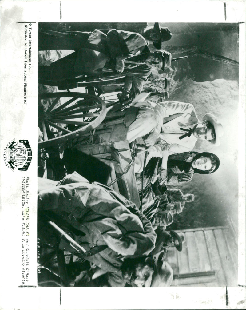 Rhett Butler and Scarlett O'Hara take flight from burning Atlanta. - Vintage Photograph