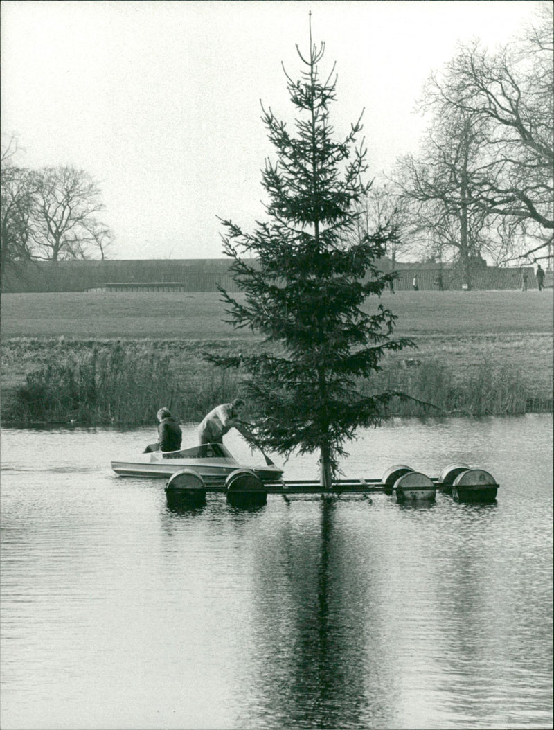 View of people riding a boat in the lake. - Vintage Photograph