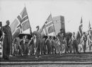 Soldiers gathered while holding the England flag during WWI,1944. - Vintage Photograph