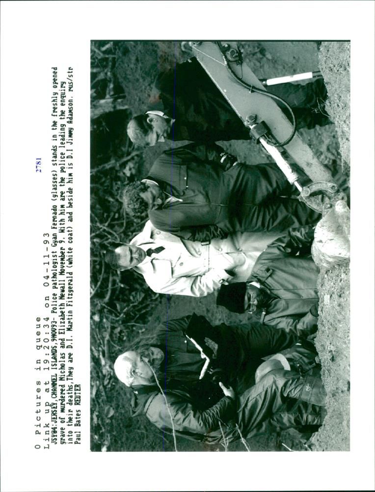 Gyan Fernado stands in the freshly opened grave of murdered Nicholas and Elizabeth Newall. - Vintage Photograph