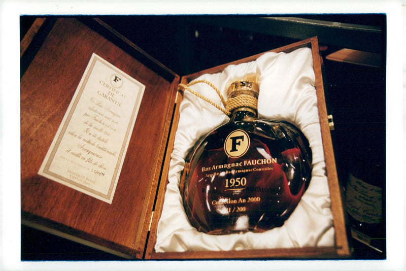 A bottle of Armagnac is sold in Fauchon at the Place de la Madeleine in Paris - Vintage Photograph